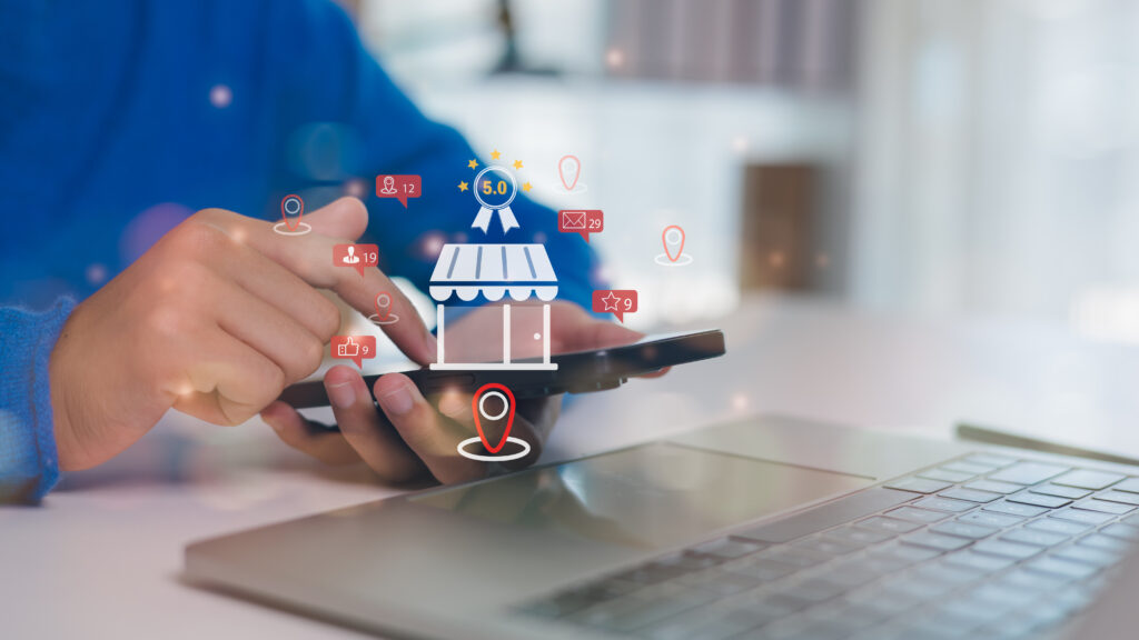 Person using a smartphone to manage online business reviews and digital marketing interactions.